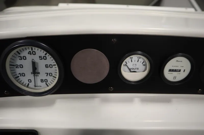 Slide: The Image of Dashboard of a 1994 San Pan 2500 with RPM and voltage gauges. - 17