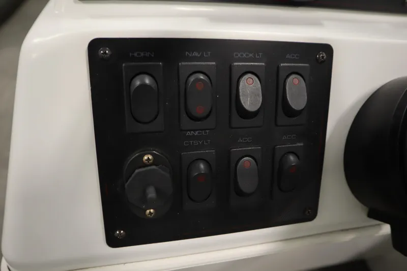 Slide: The Image of Control panel of a 1994 San Pan 2500 boat with various switches. - 18