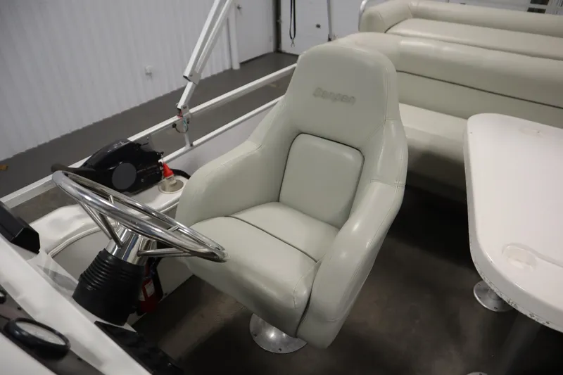 Slide: The Image of Interior of a 1994 San Pan 2500 boat with steering wheel and seating. - 22
