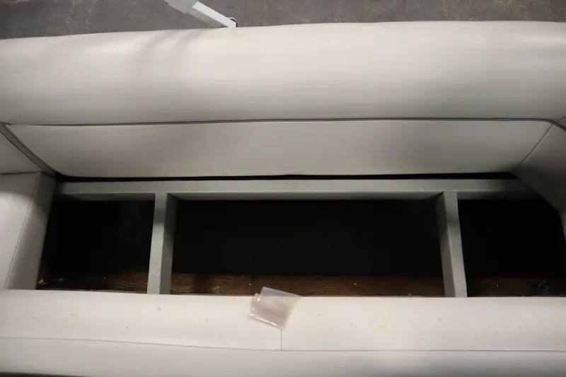 Slide: The Image of White San Pan 2500 boat seat storage compartment, 1994 model, with visible framework. - 24