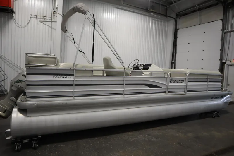 Slide: The Image of San Pan 2500 pontoon boat, 1994 model, in a garage setting. - 3