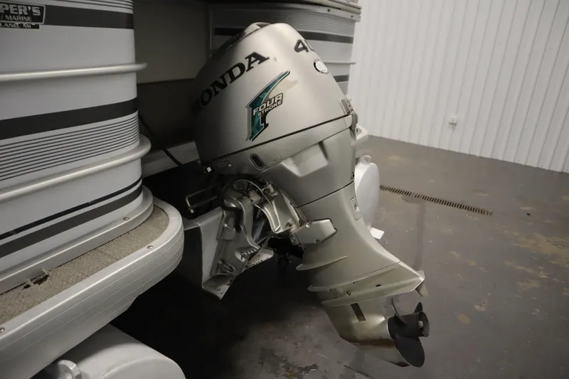 Slide: The Image of Outboard motor on a 1994 San Pan 2500 pontoon boat in a garage. - 30