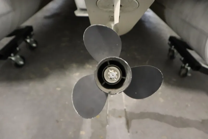 Slide: The Image of Propeller of a 1994 San Pan 2500 boat, close-up view in a garage setting. - 32