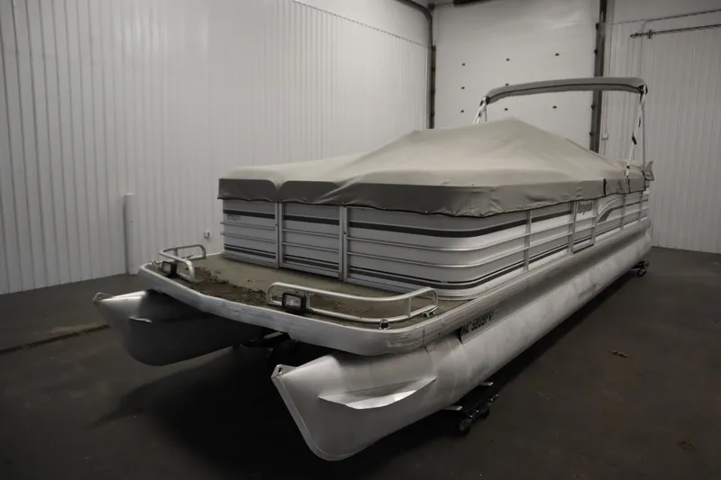 Slide: The Image of Covered 1994 San Pan 2500 pontoon boat in storage facility. - 33
