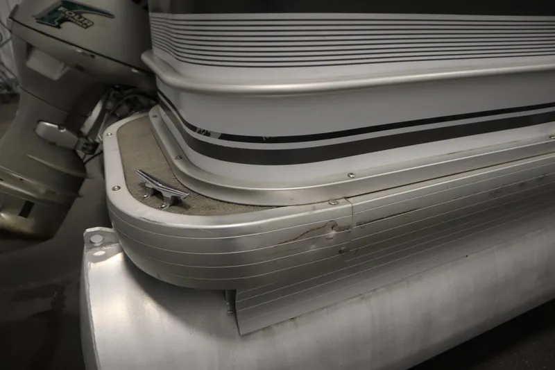 Slide: The Image of Close-up of a 1994 San Pan 2500 pontoon boat with motor detail. - 36