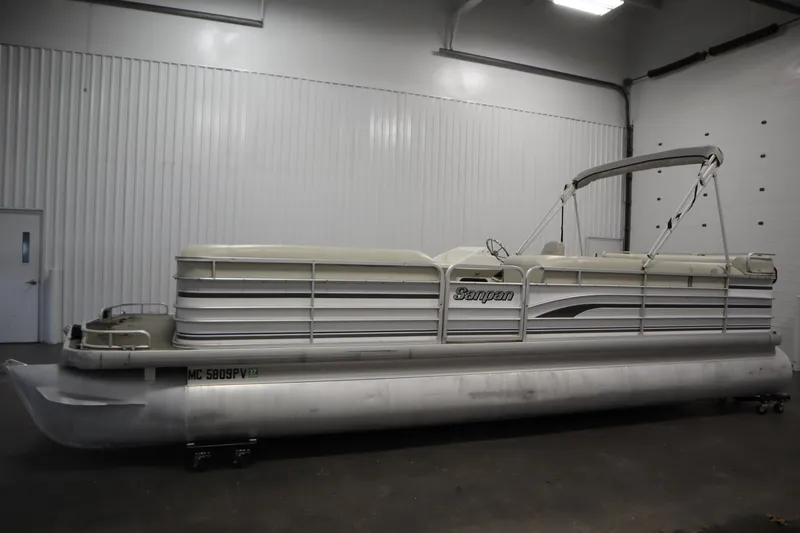 Slide: The Image of 1994 San Pan 2500 pontoon boat in indoor storage facility. - 7