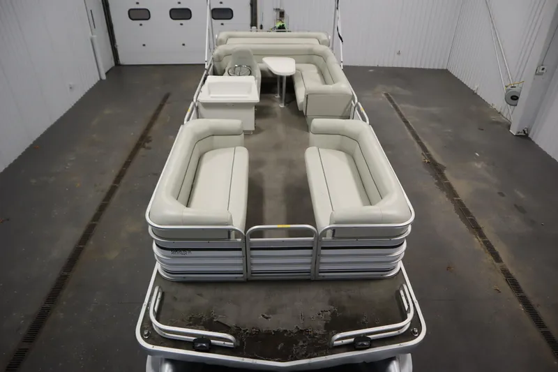 Slide: The Image of San Pan 2500 pontoon boat, 1994 model, with spacious seating in a garage setting. - 8