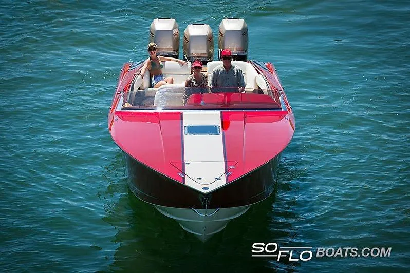 Slide: The Image of 2026 Nor-Tech 360 Monte Carlo Flyer boat cruising with three passengers on a sunny day. - 2