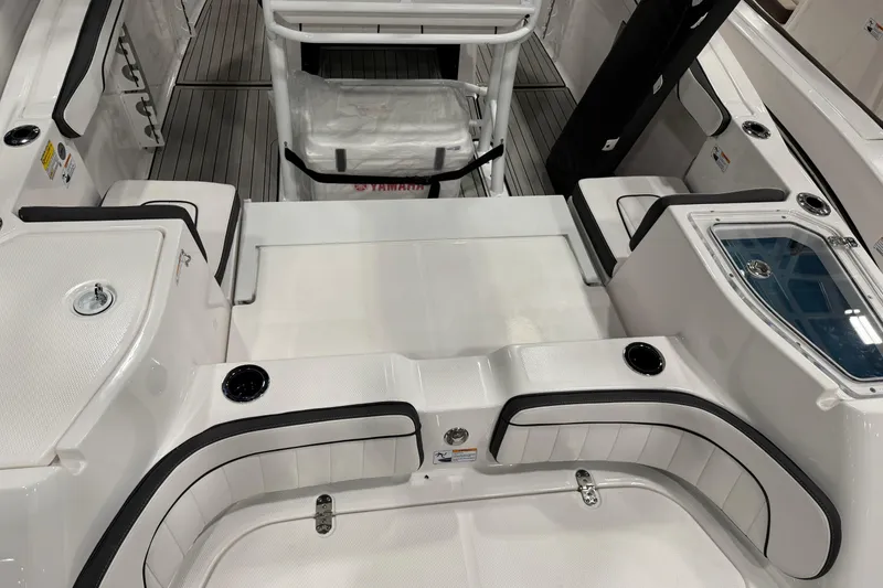 Slide: The Image of 2025 Yamaha Boats 252 FSH Sport interior with seating and storage compartments. - 2