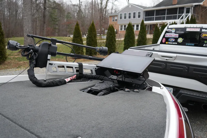 Slide: The Image of 2021 Skeeter FXR21 Apex boat with advanced navigation equipment, parked near a house. - 10