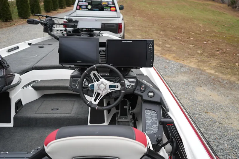 Slide: The Image of 2021 Skeeter FXR21 Apex boat cockpit with advanced navigation screens and steering wheel. - 13