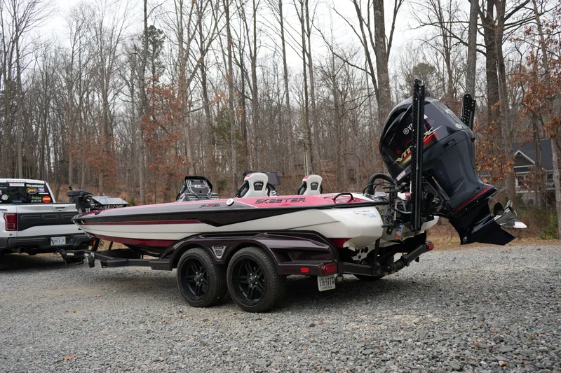 Slide: The Image of 2021 Skeeter FXR21 Apex boat on trailer in wooded area. - 4