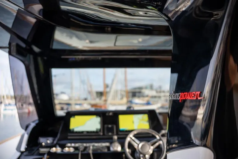 Slide: The Image of 2026 Solaris Power 44 Sport Turismo yacht cockpit with navigation screens and steering wheel. - 12