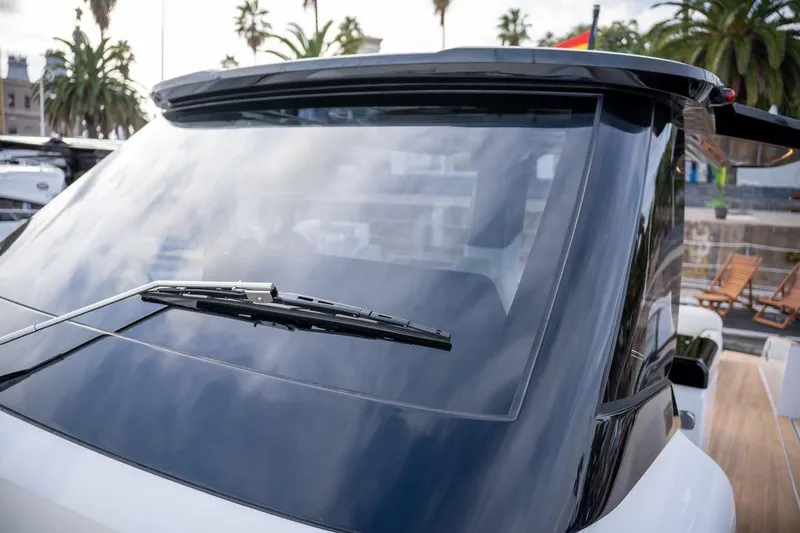 Slide: The Image of 2026 Solaris Power 44 Sport Turismo yacht windshield with sleek design and palm trees in background. - 15