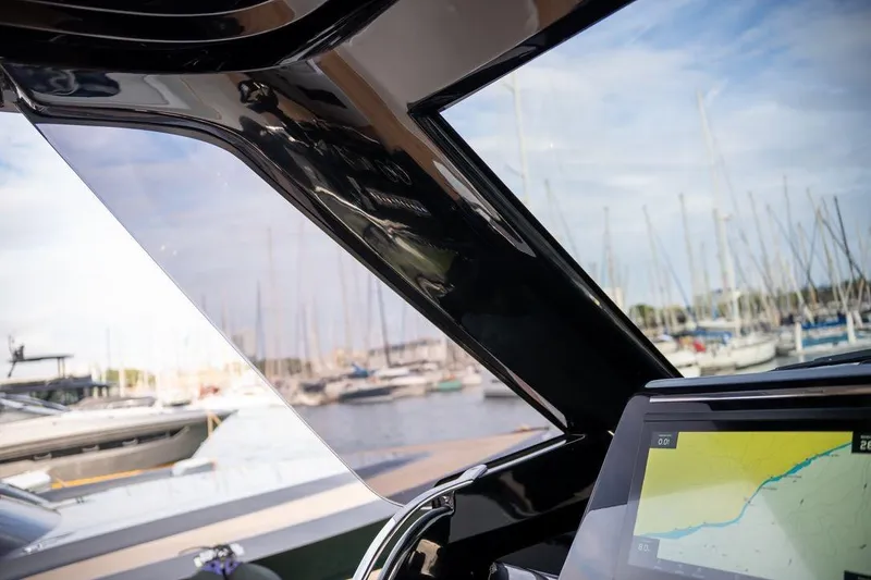 Slide: The Image of 2026 Solaris Power 44 Sport Turismo yacht interior with navigation display, marina view. - 7
