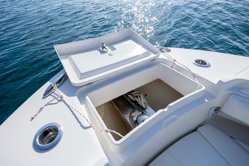 Slide: The Image of 2022 Regulator 31 boat anchor compartment open on calm blue water. - 11