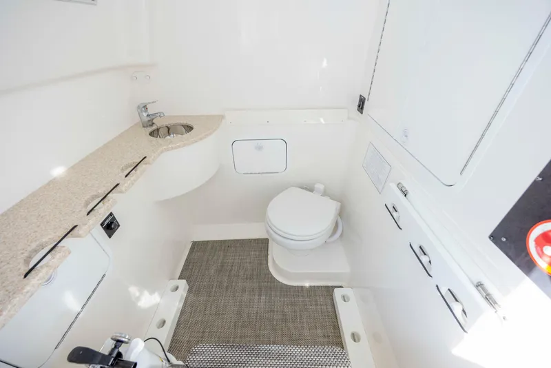 Slide: The Image of 2022 Regulator 31 boat interior bathroom with sink, toilet, and storage. - 14