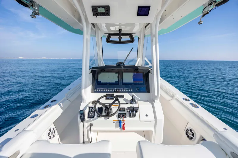 Slide: The Image of 2022 Regulator 31 boat cockpit with advanced navigation system on open sea. - 18