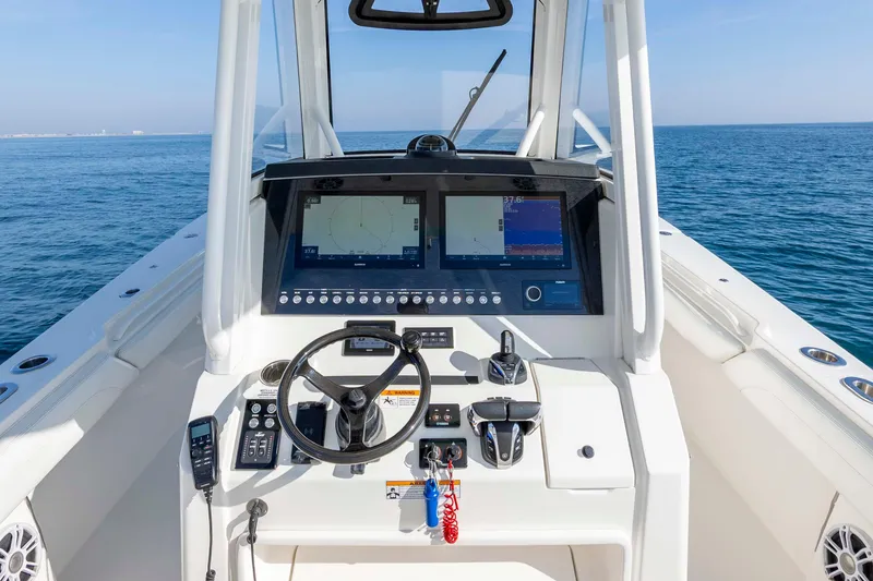 Slide: The Image of 2022 Regulator 31 boat cockpit with advanced navigation system on open water. - 19