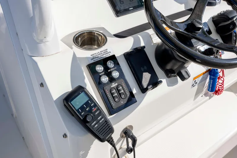 Slide: The Image of Control panel of 2022 Regulator 31 boat with steering wheel and communication device. - 20