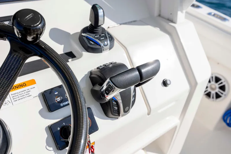 Slide: The Image of Control panel of 2022 Regulator 31 boat with steering wheel and throttle. - 23