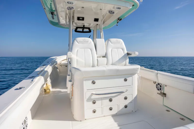 Slide: The Image of 2022 Regulator 31 boat interior with white seating, ocean view, and clear blue sky. - 24