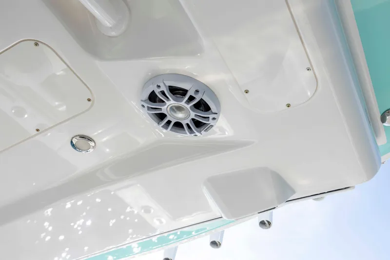 Slide: The Image of 2022 Regulator 31 boat detail showing speaker and sleek white finish. - 26