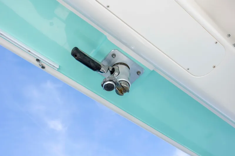 Slide: The Image of 2022 Regulator 31 boat detail with handle against blue sky background. - 27