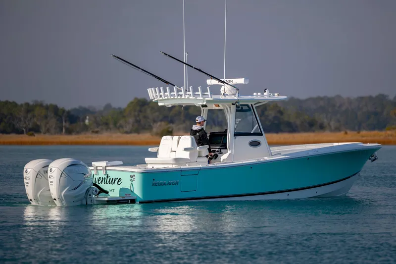 Slide: The Image of 2022 Regulator 31 boat with dual Yamaha engines on calm water. - 3