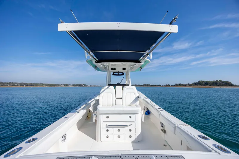 Slide: The Image of 2022 Regulator 31 boat on calm water under clear blue sky. - 31