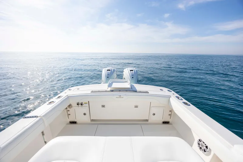 Slide: The Image of 2022 Regulator 31 boat on open sea, clear sky, dual engines visible. - 35