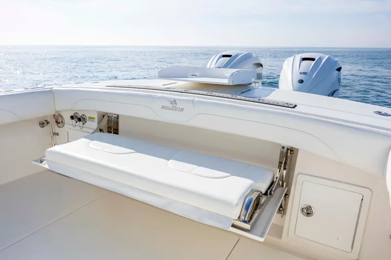 Slide: The Image of 2022 Regulator 31 boat with foldable seating and dual engines on open water. - 36