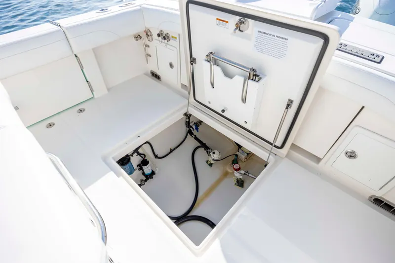 Slide: The Image of 2022 Regulator 31 boat storage compartment with open hatch, revealing internal components. - 38