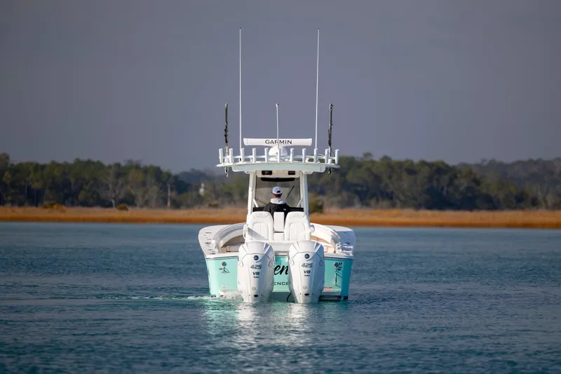 Slide: The Image of 2022 Regulator 31 boat with twin Yamaha 425 V8 engines on calm water. - 4
