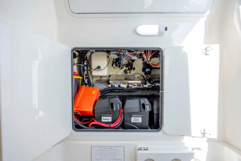 Slide: The Image of 2022 Regulator 31 boat battery compartment with wiring and labeled batteries. - 40