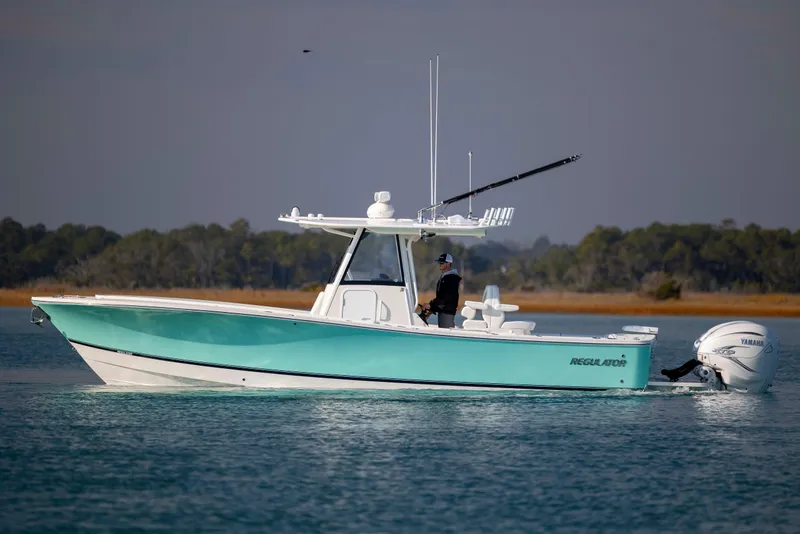 Slide: The Image of 2022 Regulator 31 boat on calm water, featuring Yamaha outboard engines. - 6