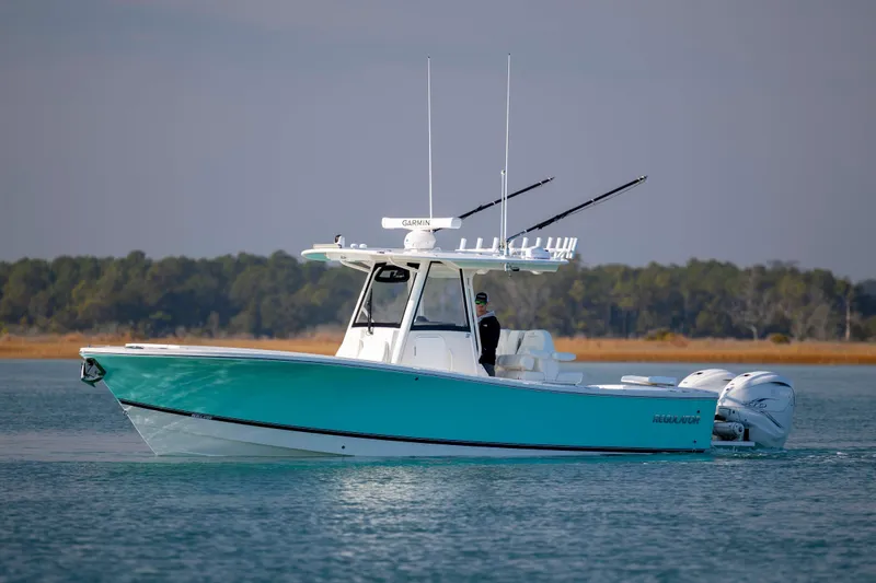 Slide: The Image of 2022 Regulator 31 boat on calm water with scenic background. - 7