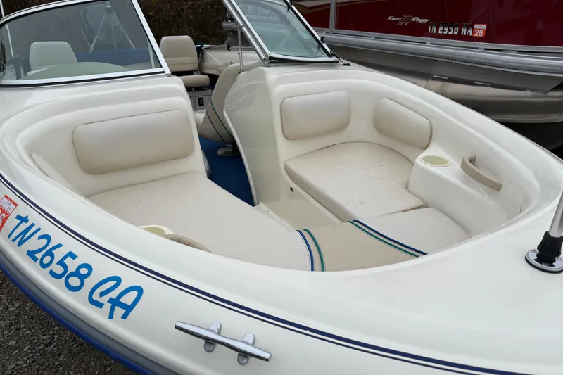 Slide: The Image of 1996 Sea Ray 175 Bow Rider boat with white seating and blue accents. - 2
