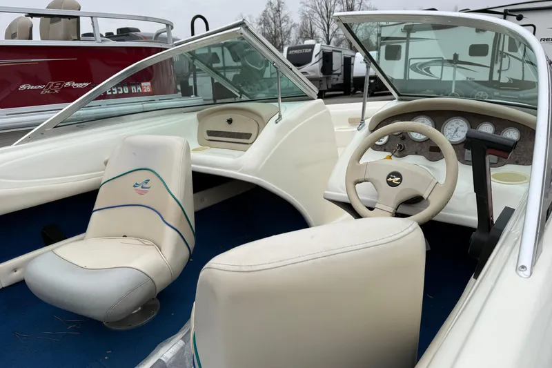 Slide: The Image of 1996 Sea Ray 175 Bow Rider interior with steering wheel and seating. - 4
