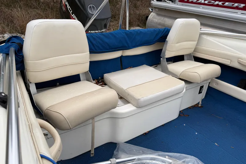 Slide: The Image of 1996 Sea Ray 175 Bow Rider interior with beige seats and blue carpet. - 5