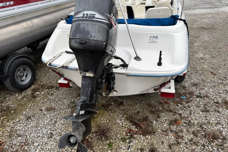 Slide: The Image of 1996 Sea Ray 175 Bow Rider with outboard motor on gravel surface. - 6
