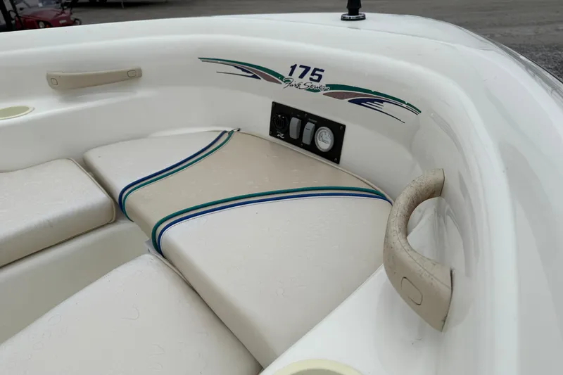 Slide: The Image of 1996 Sea Ray 175 Bow Rider interior with beige seating and blue-green accents. - 7