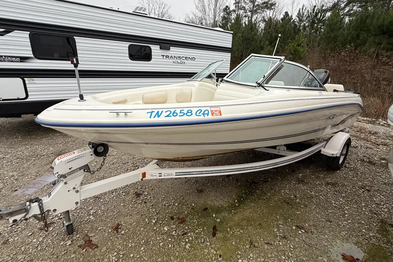 Slide: The Image of 1996 Sea Ray 175 Bow Rider boat on trailer, parked beside a camper. - 8