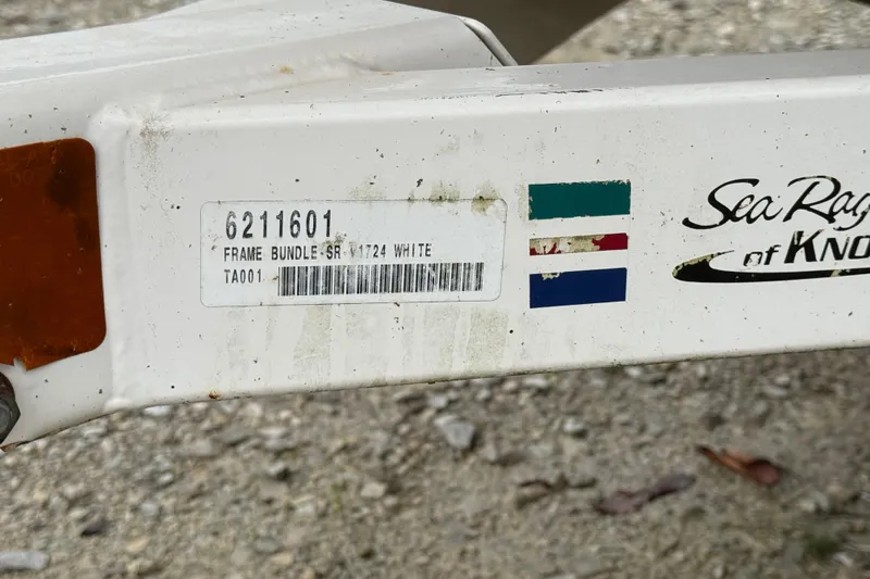 Slide: The Image of 1996 Sea Ray 175 Bow Rider trailer frame with identification label and logo. - 9