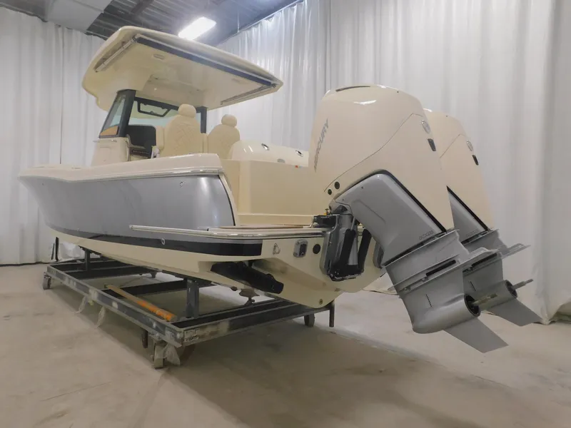 Slide: The Image of 2023 Chris-Craft Catalina 30 with dual outboard engines in a boat storage facility. - 4