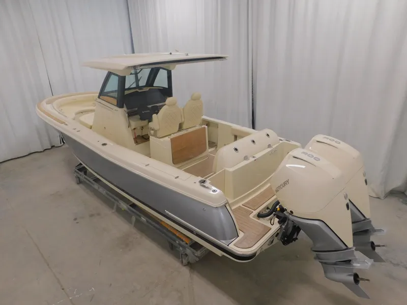 Slide: The Image of 2023 Chris-Craft Catalina 30 helm with modern controls and dual displays in a boat garage. - 6