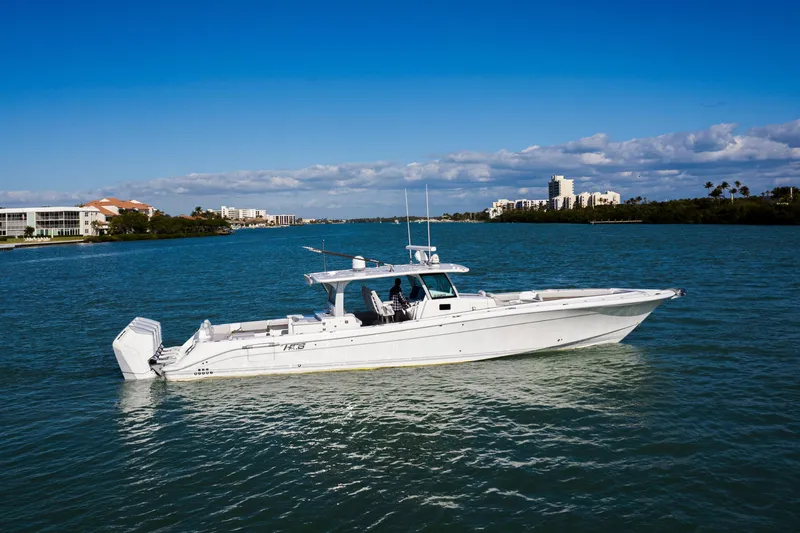 Slide: The Image of 2024 HCB 53 Sueños luxury boat cruising on a sunny day in a scenic waterway. - 5