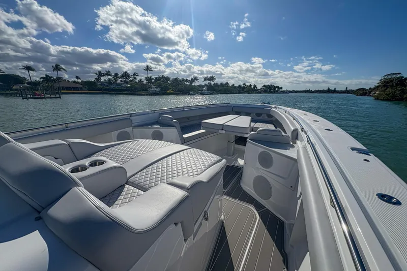 Slide: The Image of Luxurious 2024 HCB 53 Sueños boat interior with plush seating, cruising on a sunny day. - 38