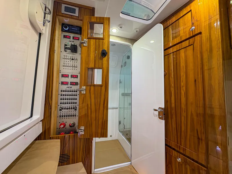 Slide: The Image of 2024 HCB 53' Suenos interior with wood paneling and control panel. - 13