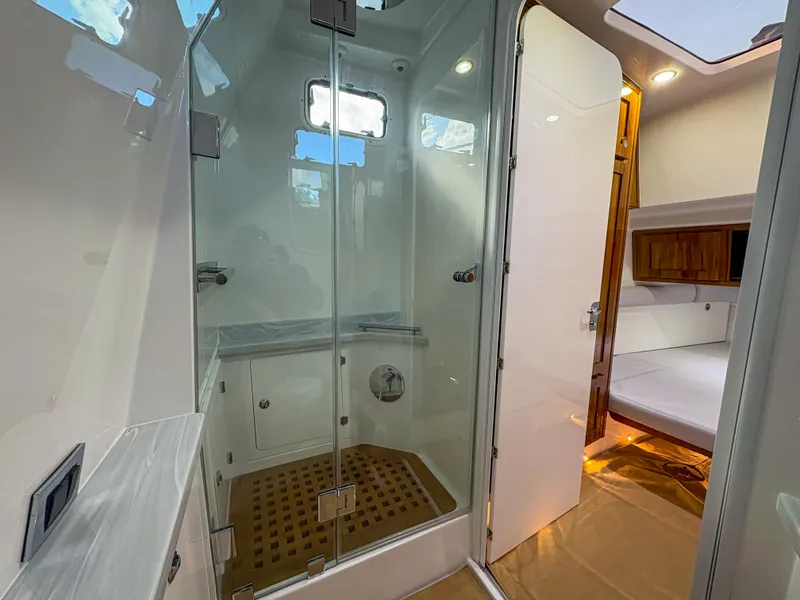 Slide: The Image of 2024 HCB 53' Suenos yacht interior with modern shower and cozy cabin. - 16
